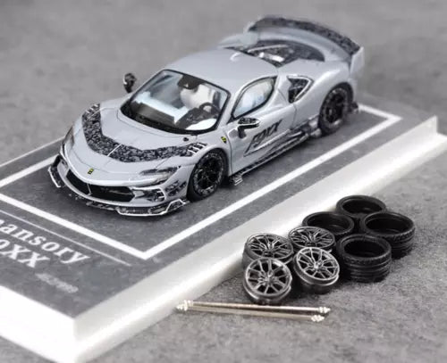 Diecast racing sports car model with spare wheels and tools on display base