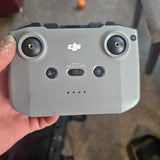 Gray DJI drone remote controller with dual joysticks and front buttons