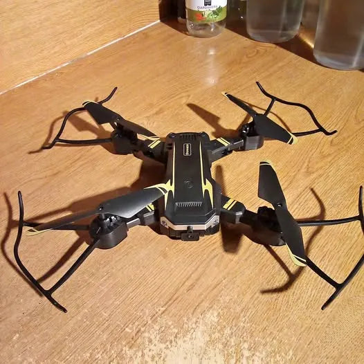 Black quadcopter drone with four rotors and landing gear