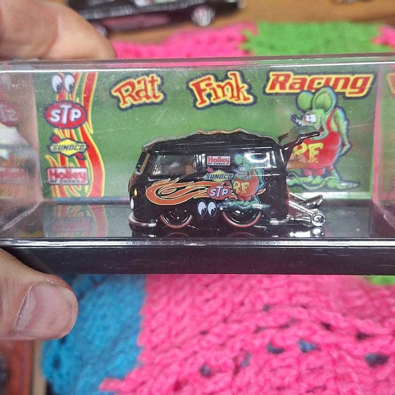 Diecast bus model in clear blister with green racing graphic and black body