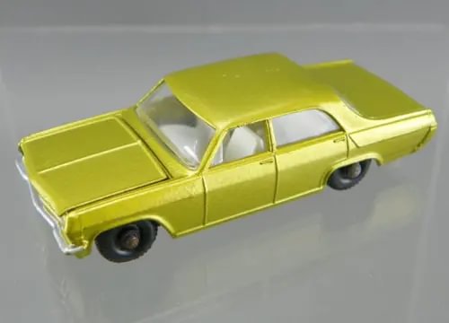 Vintage diecast Opel Diplomat car, gold/yellow, 1960s style, open windows, wheels visible