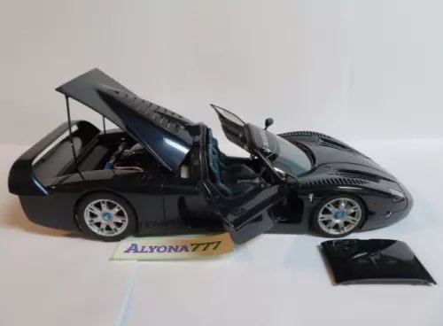 Diecast road car model in black with dark blue details, open gull-wing doors