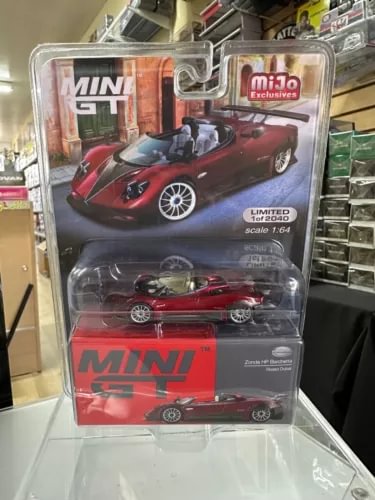 Red PAGANI diecast sports car model in clear blister packaging, 1/64 scale