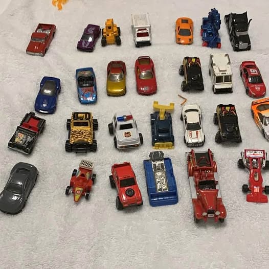 Assorted diecast toy cars, various colors and styles, sold as a lot.