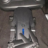 Black drone body with blue power indicator and folding arms