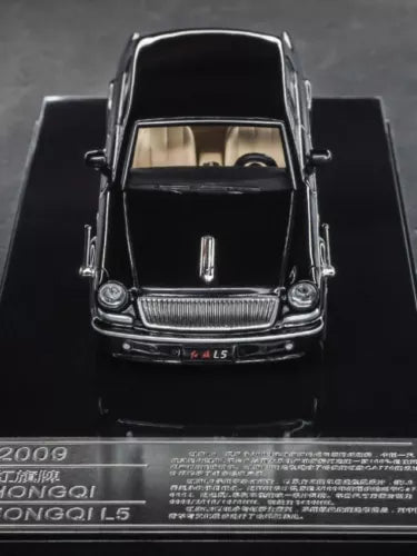 Black diecast model car front view in display box