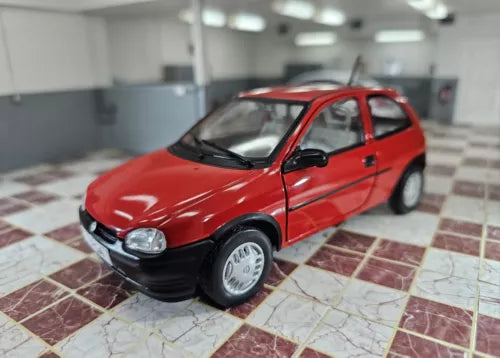 Red 1/24 scale diecast hatchback model car with black hood, front-left view