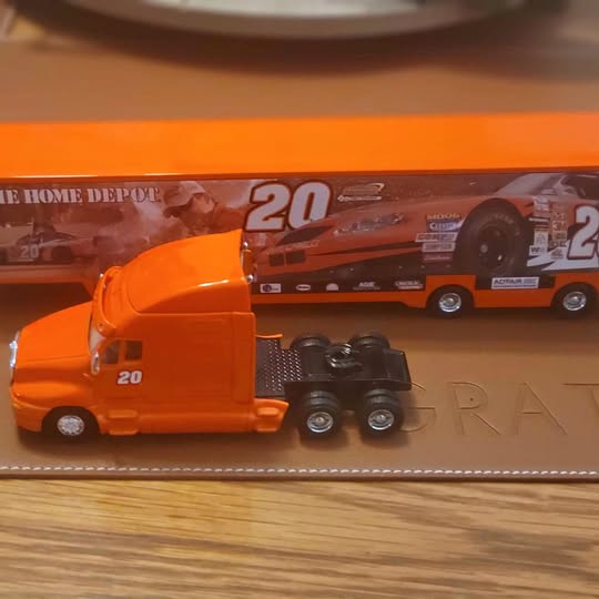 Orange diecast NASCAR-style hauler truck with trailer, Tony Stewart #20 graphics