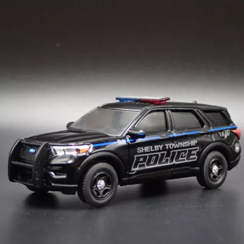 Black diecast police SUV model car with blue stripes and Shelby Township Police text