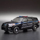 Black diecast police SUV model car with blue stripes and Shelby Township Police text