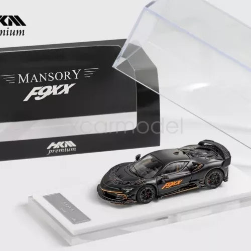 1:64 scale diecast racing sports car model, black with orange accents, with box