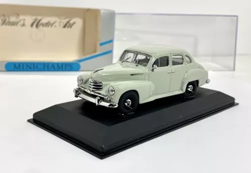 Minichamps 1:43 diecast classic sedan model in light gray, front 3/4 on display base