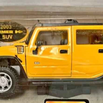 Yellow diecast H2 Hummer SUV 1:24 model, side view with window and door details