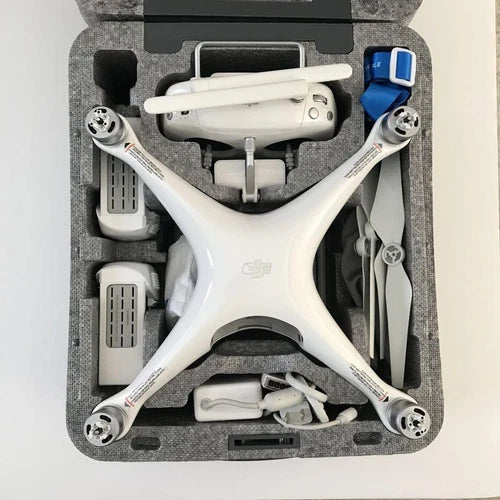 White Dji Phantom 4 drone in hard case with propellers and accessory compartments