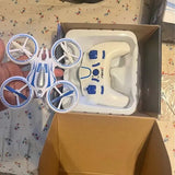 Blue-and-white quadcopter drone with prop guards in open retail box