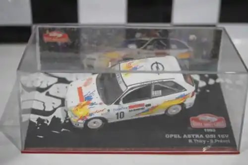 Diecast Opel Astra GSi model car in clear display case, white with racing stripes