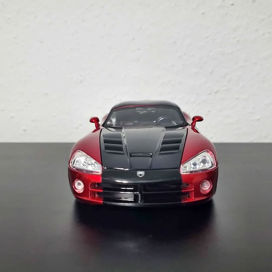 Red and black diecast Viper SRT10 toy car, front view with grille and headlights