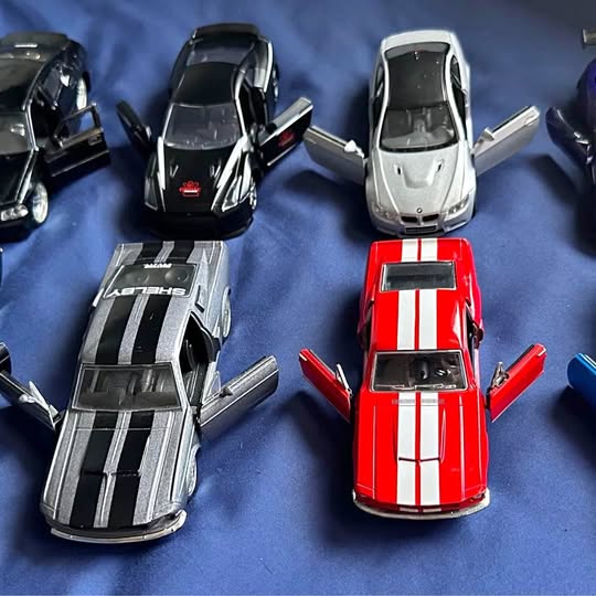 Diecast car set of four models in black, silver, white, and red stripes