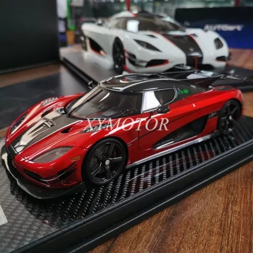 Red and black 1/18 diecast model car with glossy finish on black display base