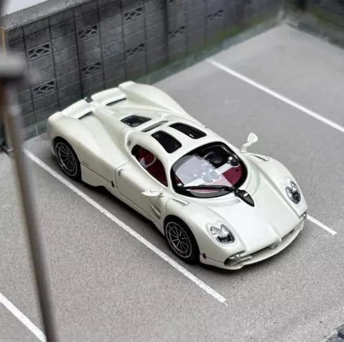 White 1:64 racing sports coupe diecast model car with black accents, front 3/4 view