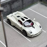 White 1:64 racing sports coupe diecast model car with black accents, front 3/4 view