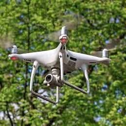 Drone photo/video service drone in flight with attached camera gimbal