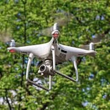 Drone photo/video service drone in flight with attached camera gimbal