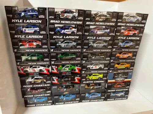 Assorted NASCAR diecast car collectibles in boxed packaging with driver names