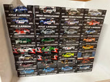 Assorted NASCAR diecast car collectibles in boxed packaging with driver names
