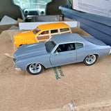 Light blue diecast classic car with white roof and chrome wheels