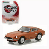 Orange 1:64 diecast model car with black hood and white-wall tires