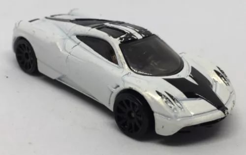 Pearl white diecast sports car with black hood stripes and black wheels, 1:64 scale