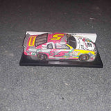 1:32 scale diecast race car on display stand, multicolor racing livery