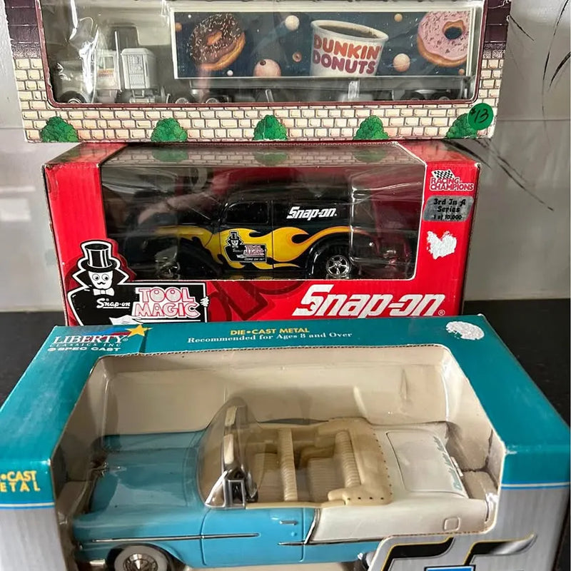 Die-cast metal toy car in blue with white top, boxed display