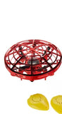 Red and black LED UFO mini drone with hovering saucer body and grid top