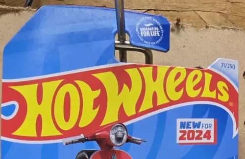 Hot Wheels 1:64 diecast car with blue and red livery, front view and emblem