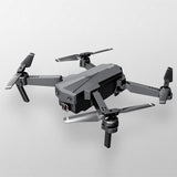 Black and gray quadcopter drone with four rotors and front 2-axis gimbal camera
