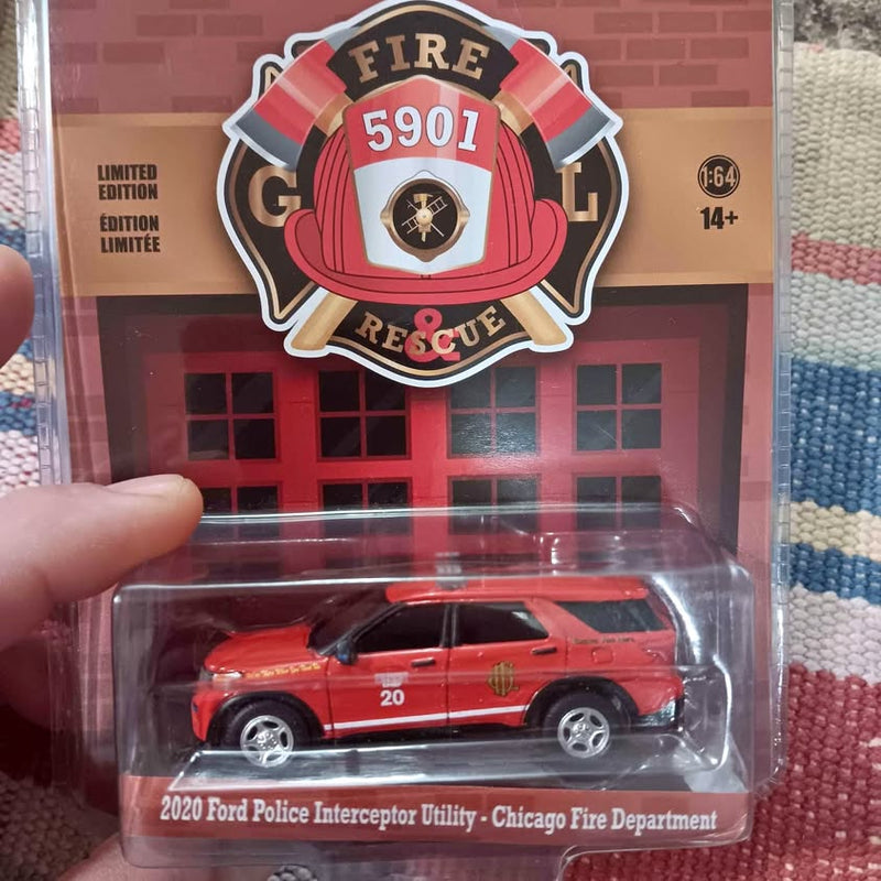 Red diecast police interceptor utility car in clear retail blister pack