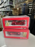 Red diecast sports car model in display box, front view