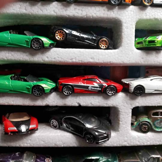 1/64 scale diecast model cars in foam tray, assorted colors