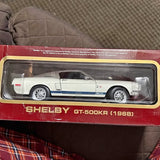 White diecast model car with blue racing stripe, in clear display box