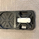 Foldable quadcopter drone in hard case, white and dark gray, top view