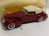 Maroon diecast convertible model car with cream roof and chrome details