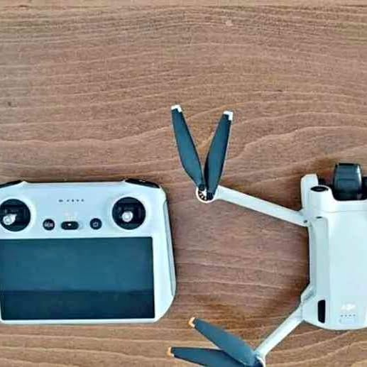 DJI Mini 3 Pro drone and remote controller with visible screen and propellers