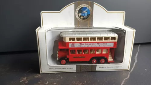 Red diecast mission bus model with wheels, displayed in retail box
