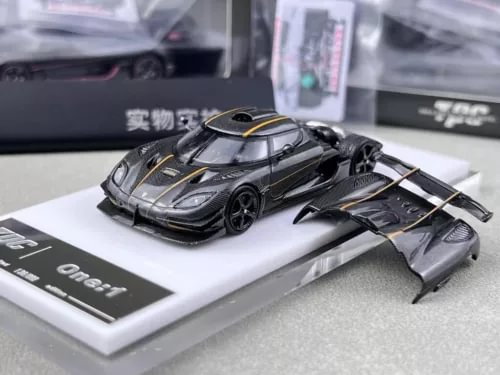 Diecast metal racing sport model car in dark gray with gold stripe details