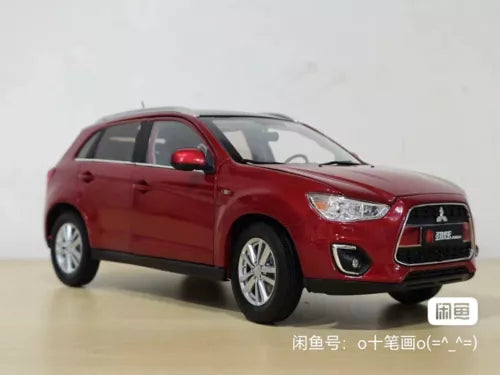 Red diecast car model, front three-quarter view with grille and headlights.