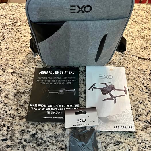 EXO drone carrying case with printed instruction cards and drone package sleeve