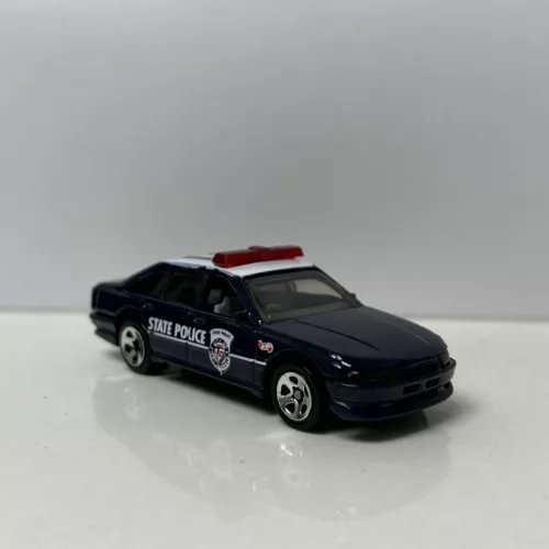 Police diecast car model, dark blue sedan with red roof and State Police decals