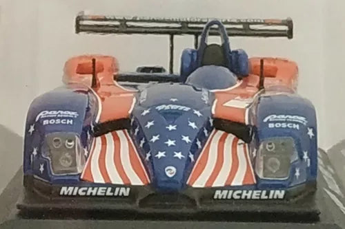 Diecast race car with blue nose, star pattern, orange side pods, Michelin decals